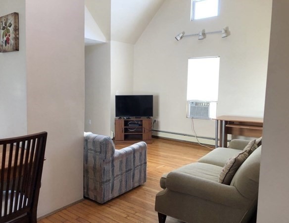 138 Ferry Street, Unit 2 Everett, MA 02149 - Photo 9 of 18 a living room with furniture and a flat screen tv