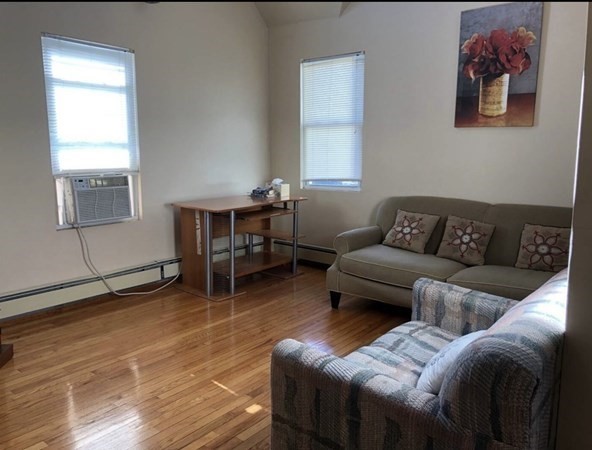 138 Ferry Street, Unit 2 Everett, MA 02149 - Photo 10 of 18 a living room with furniture a window and a table