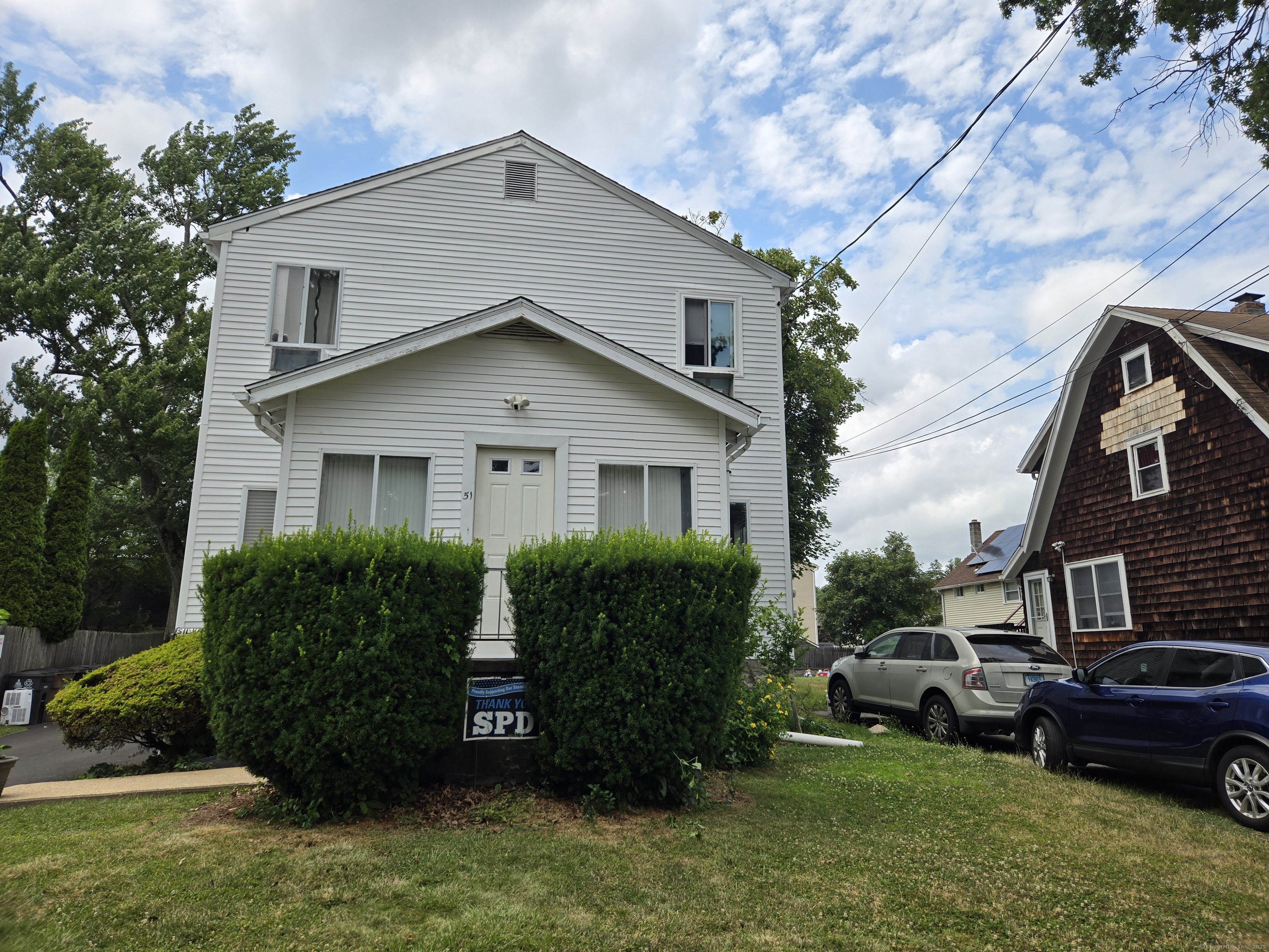 51 Center Street, Unit 2 Stamford, CT 06906 - Photo 1 of 1 a view of a house with a yard plants and a large tree