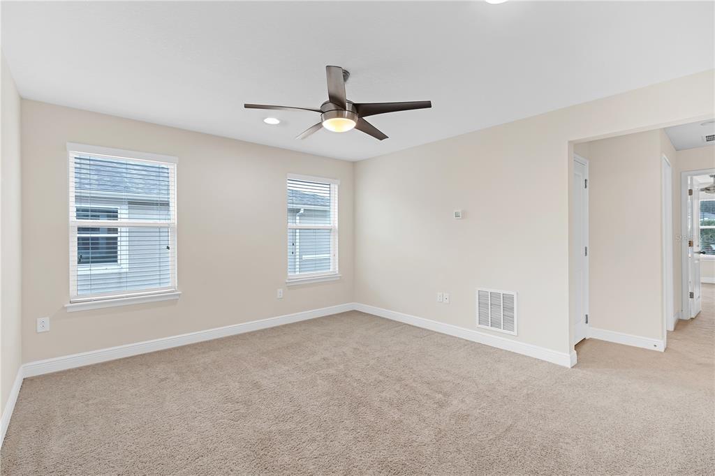 17841 Althea Blue Place Lutz, FL 33558 - Photo 22 of 38 an empty room with windows and ceiling fan