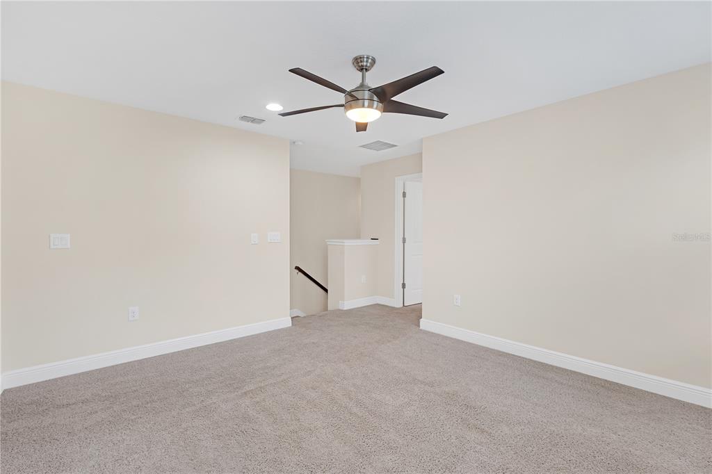 17841 Althea Blue Place Lutz, FL 33558 - Photo 23 of 38 a view of a ceiling fan with wooden floor