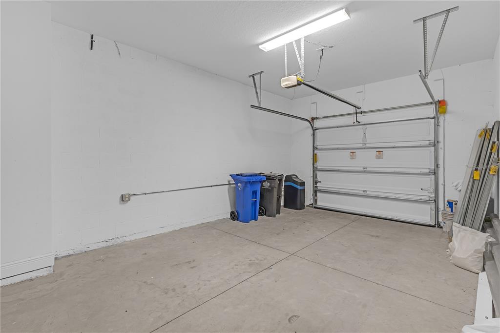 17841 Althea Blue Place Lutz, FL 33558 - Photo 30 of 38 a view of a garage with storage