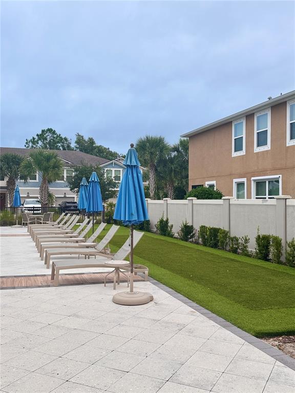 17841 Althea Blue Place Lutz, FL 33558 - Photo 37 of 38 a view of backyard with swimming pool and seating