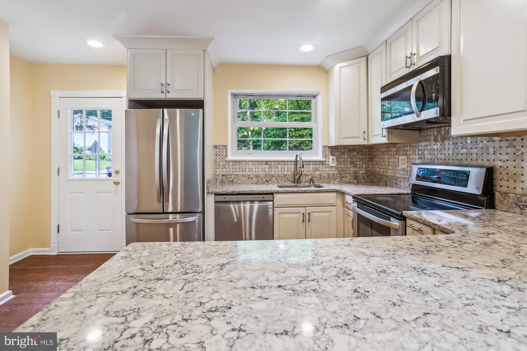 3909 Woodlawn Road Chevy Chase, MD 20815 - Photo 17 of 54 a kitchen with stainless steel appliances granite countertop a refrigerator sink and microwave
