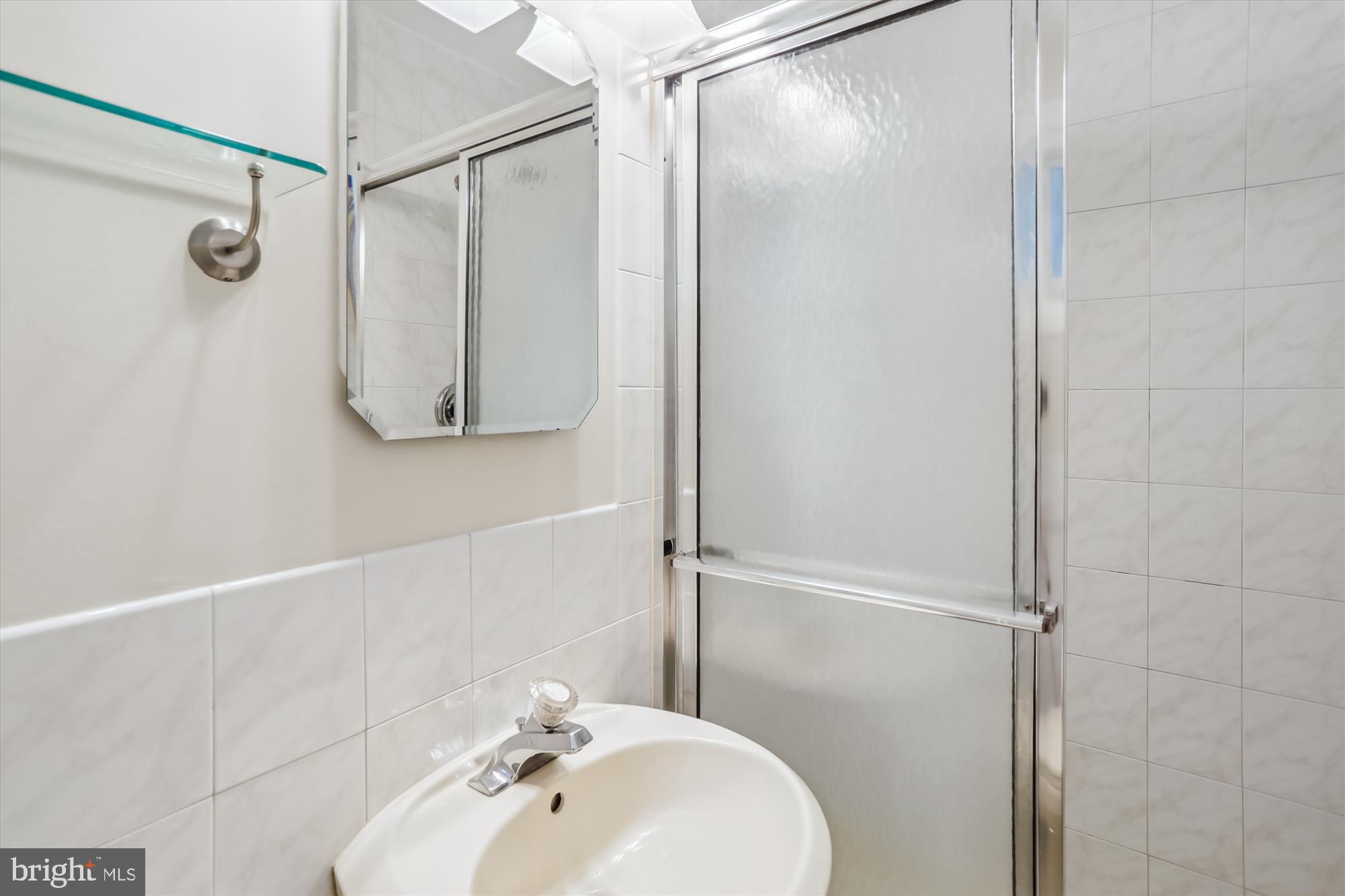 3909 Woodlawn Road Chevy Chase, MD 20815 - Photo 24 of 54 a bathroom with a shower and a sink