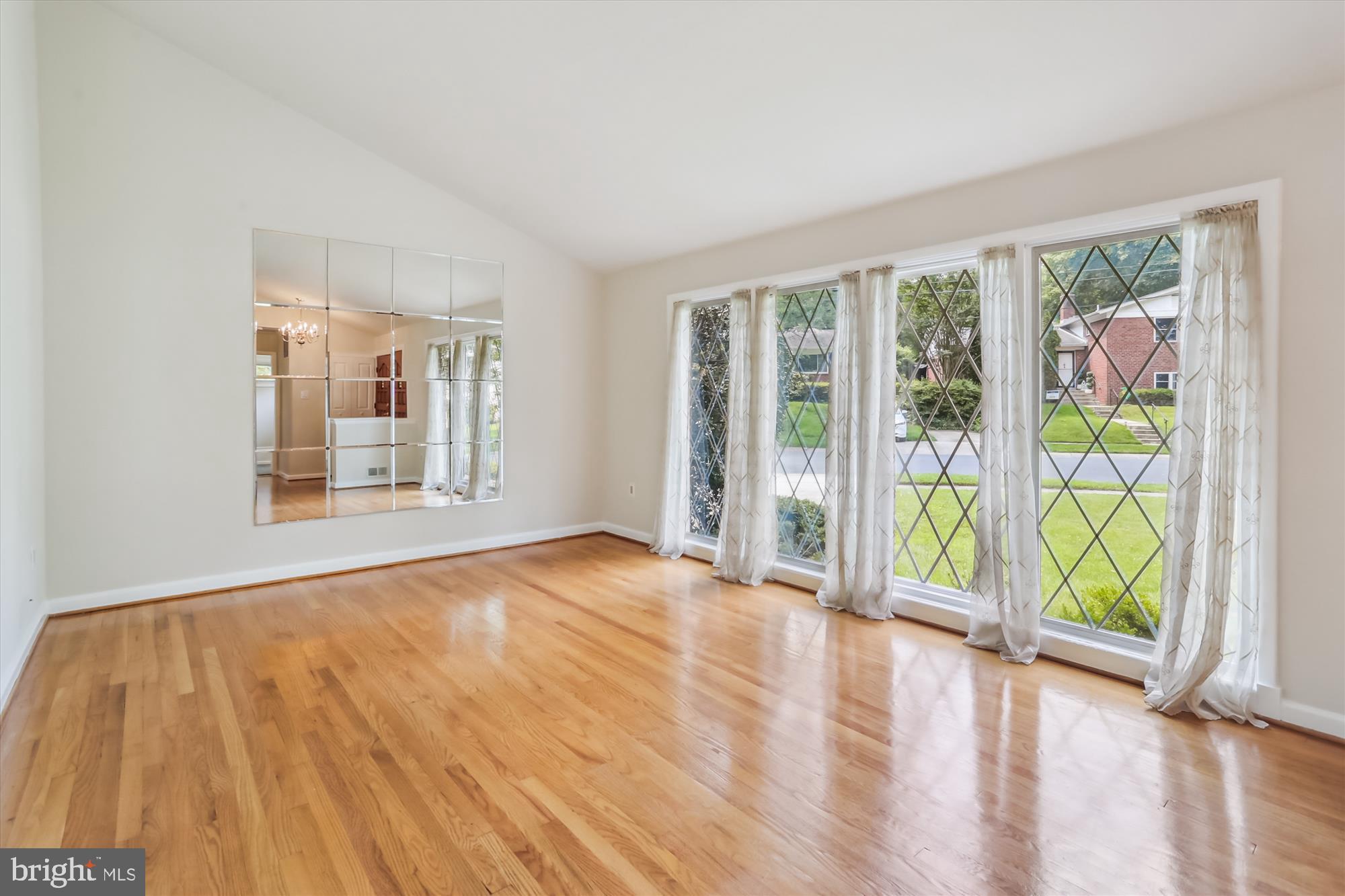 3909 Woodlawn Road Chevy Chase, MD 20815 - Photo 7 of 54 a view of an empty room with a window and wooden floor