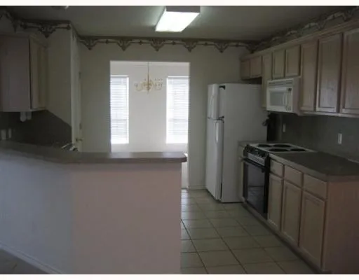 a kitchen with a refrigerator and a stove