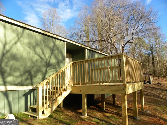 a view of balcony with wooden floor and fence