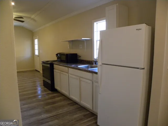 a kitchen with a refrigerator and a sink