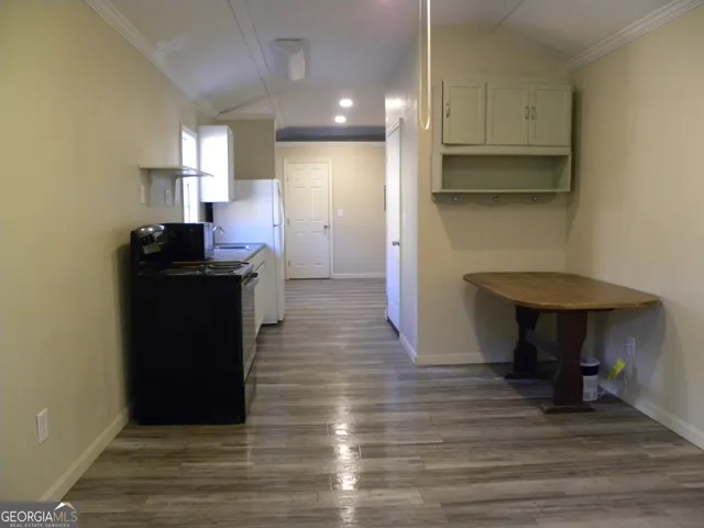 a kitchen with kitchen island wooden cabinets and a sink