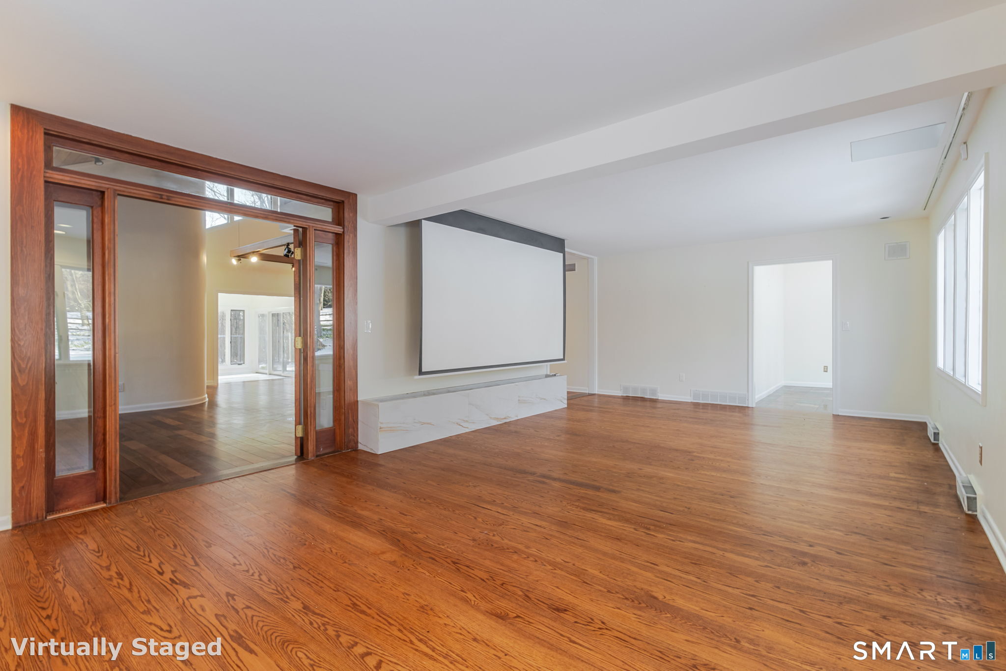 5 Mohawk Lane Woodbridge, CT 06525 - Photo 30 of 48 LIVING ROOM WITH LARGE RETRACTABLE THEATRE/TV SCREEN