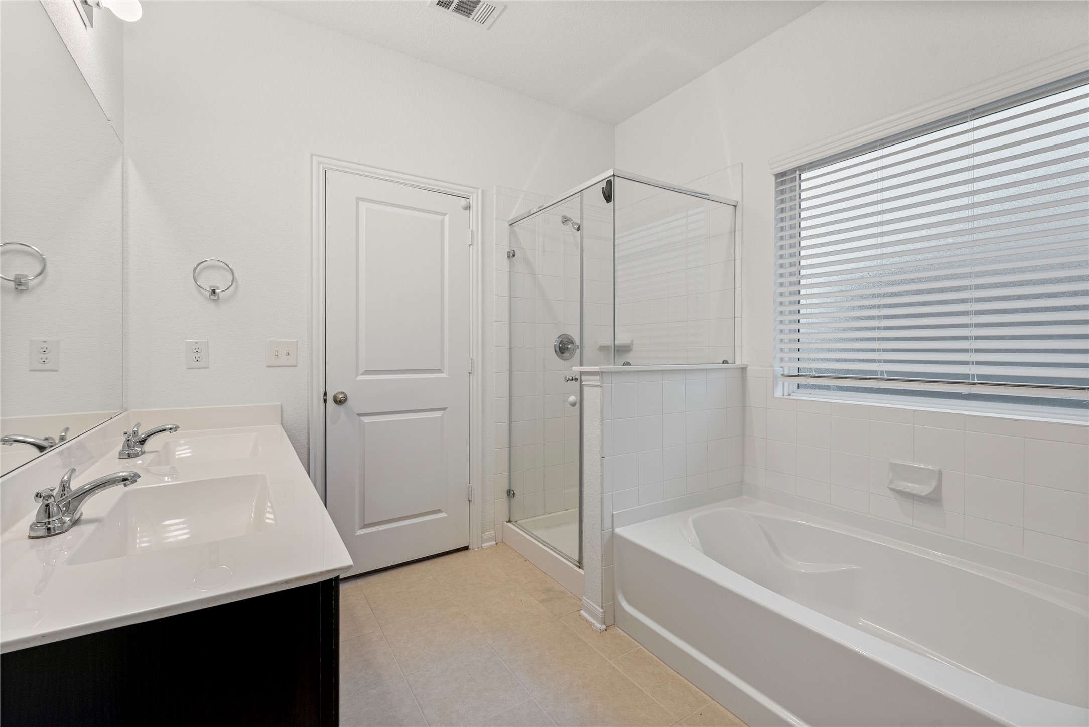 149 Biscayne Drive Kyle, TX 78640 - Photo 9 of 20 a bathroom with a tub sink vanity and a mirror