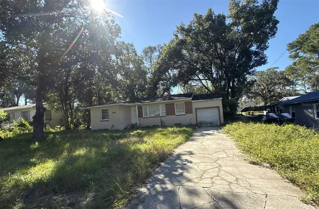 a backyard of a house with yard and barbeque oven