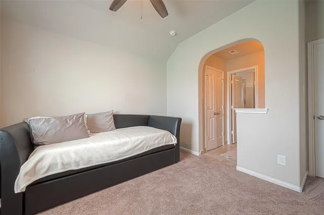 a living room with a bed and a couch