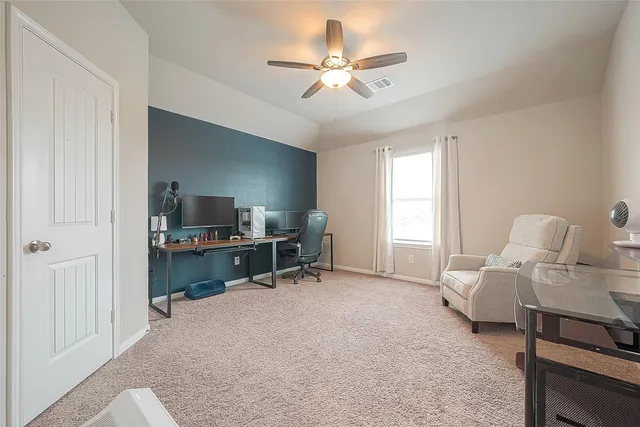 a living room with furniture a ceiling fan and a window