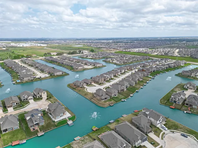 an aerial view of a city with lots of residential buildings in ocean