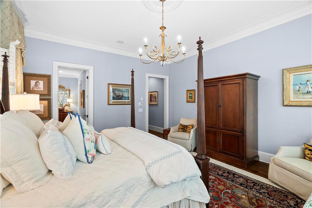 315 East Line Street Calhoun, GA 30701 - Photo 32 of 71 a bedroom with a bed chandelier and a window