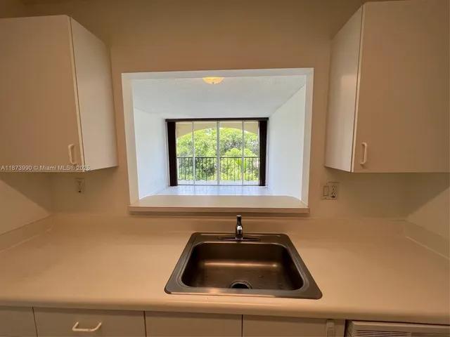 a kitchen with a sink and a window