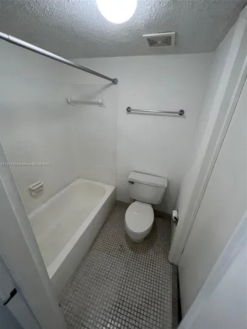 a bathroom with a sink a toilet and a shower