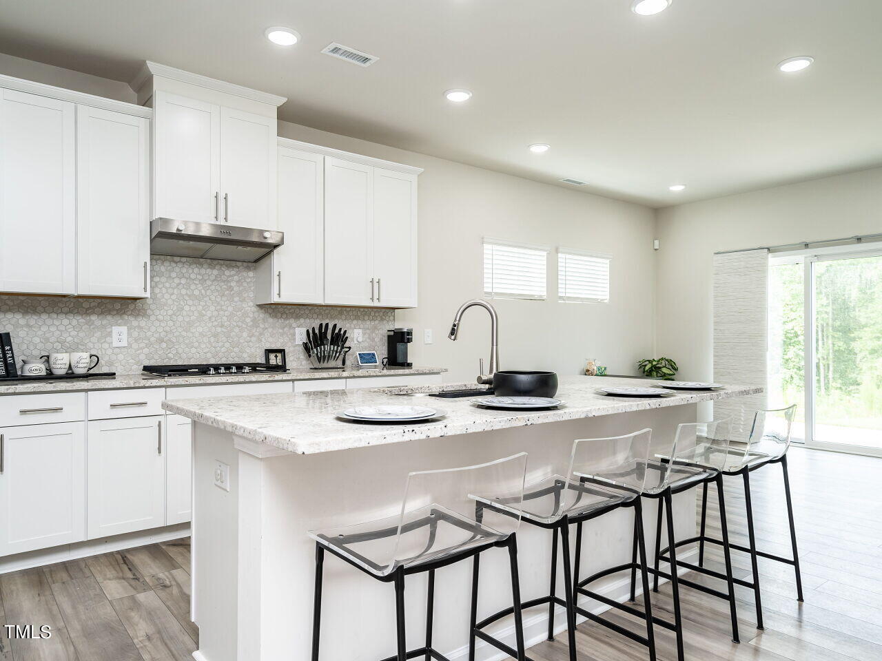 633 Embrun Run Wendell, NC 27591 - Photo 11 of 32 a kitchen with stainless steel appliances granite countertop a stove a sink dishwasher a stove and white cabinets with wooden floor