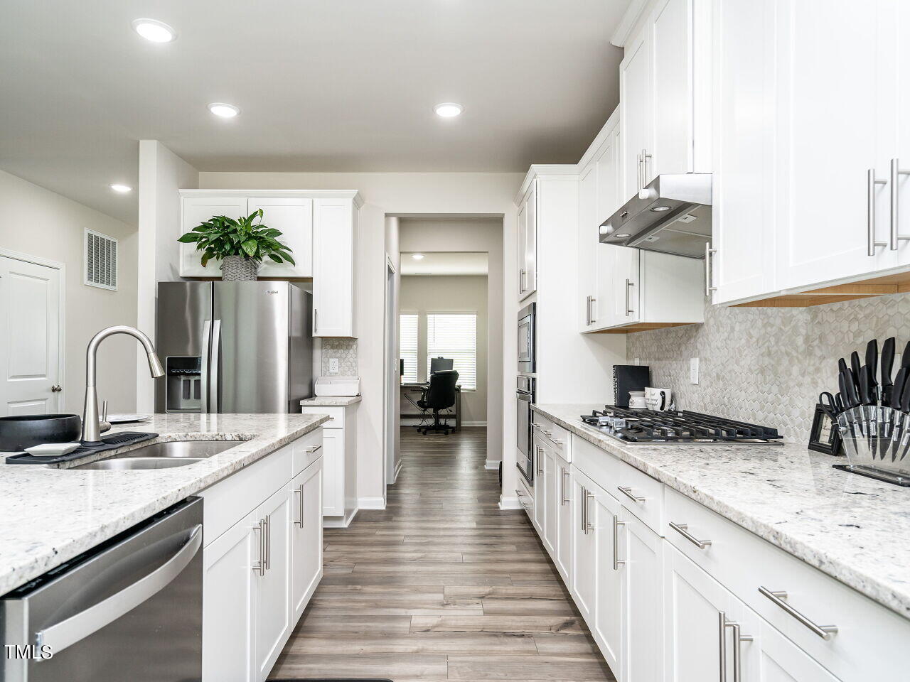 633 Embrun Run Wendell, NC 27591 - Photo 13 of 32 a kitchen with stainless steel appliances granite countertop a sink stove and cabinets