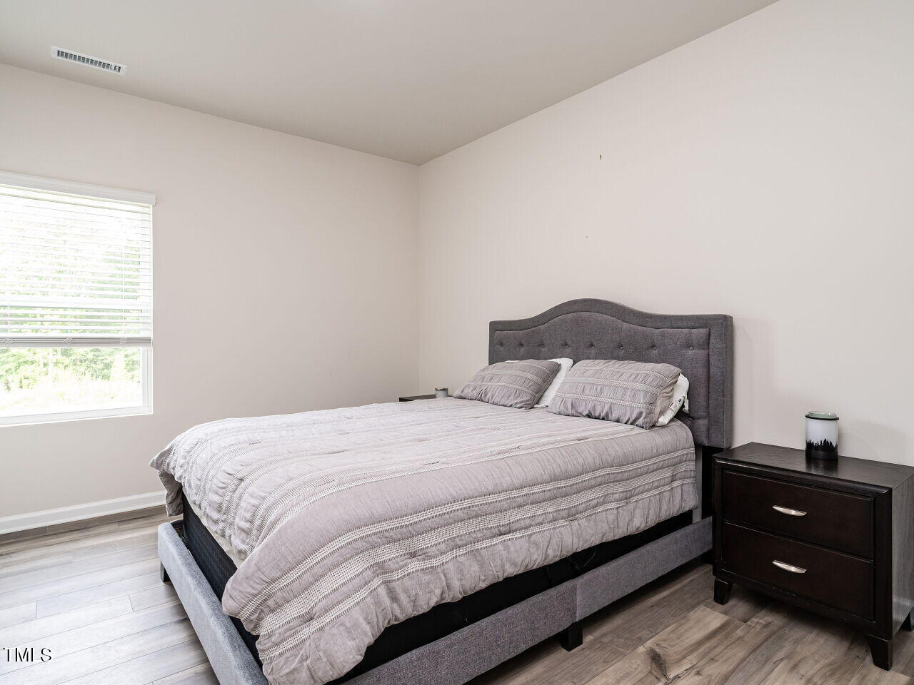 633 Embrun Run Wendell, NC 27591 - Photo 14 of 32 a bedroom with a bed and a window