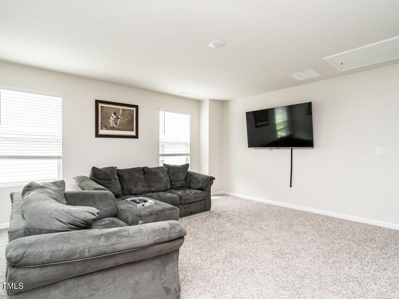 633 Embrun Run Wendell, NC 27591 - Photo 25 of 32 a living room with furniture and a flat screen tv