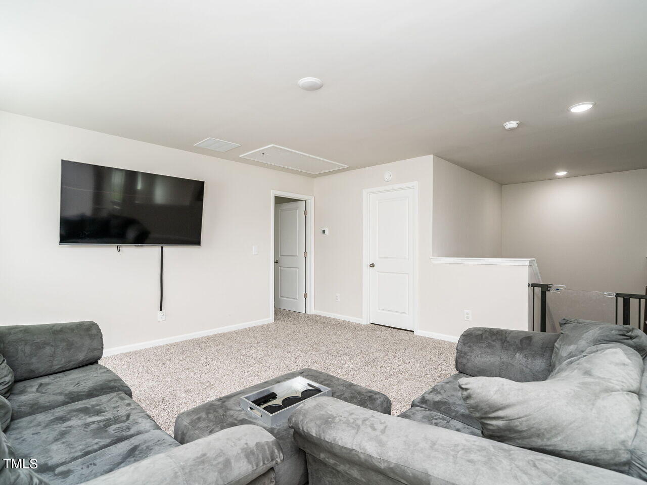 633 Embrun Run Wendell, NC 27591 - Photo 28 of 32 a living room with furniture and a flat screen tv