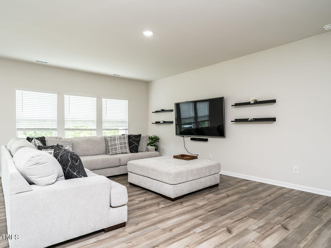 633 Embrun Run Wendell, NC 27591 - Photo 4 of 32 a living room with furniture and a flat screen tv