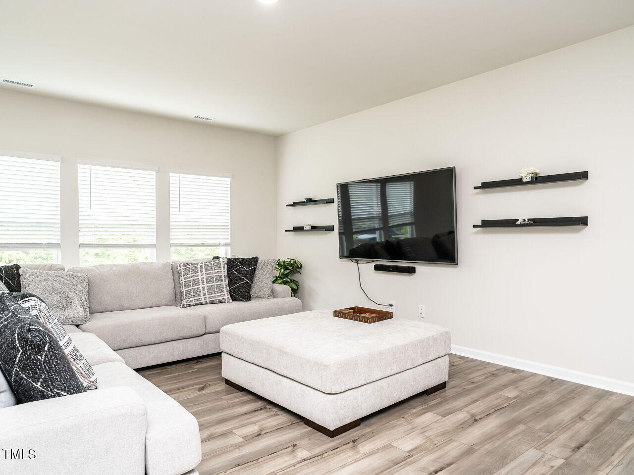 633 Embrun Run Wendell, NC 27591 - Photo 8 of 32 a living room with furniture and a flat screen tv