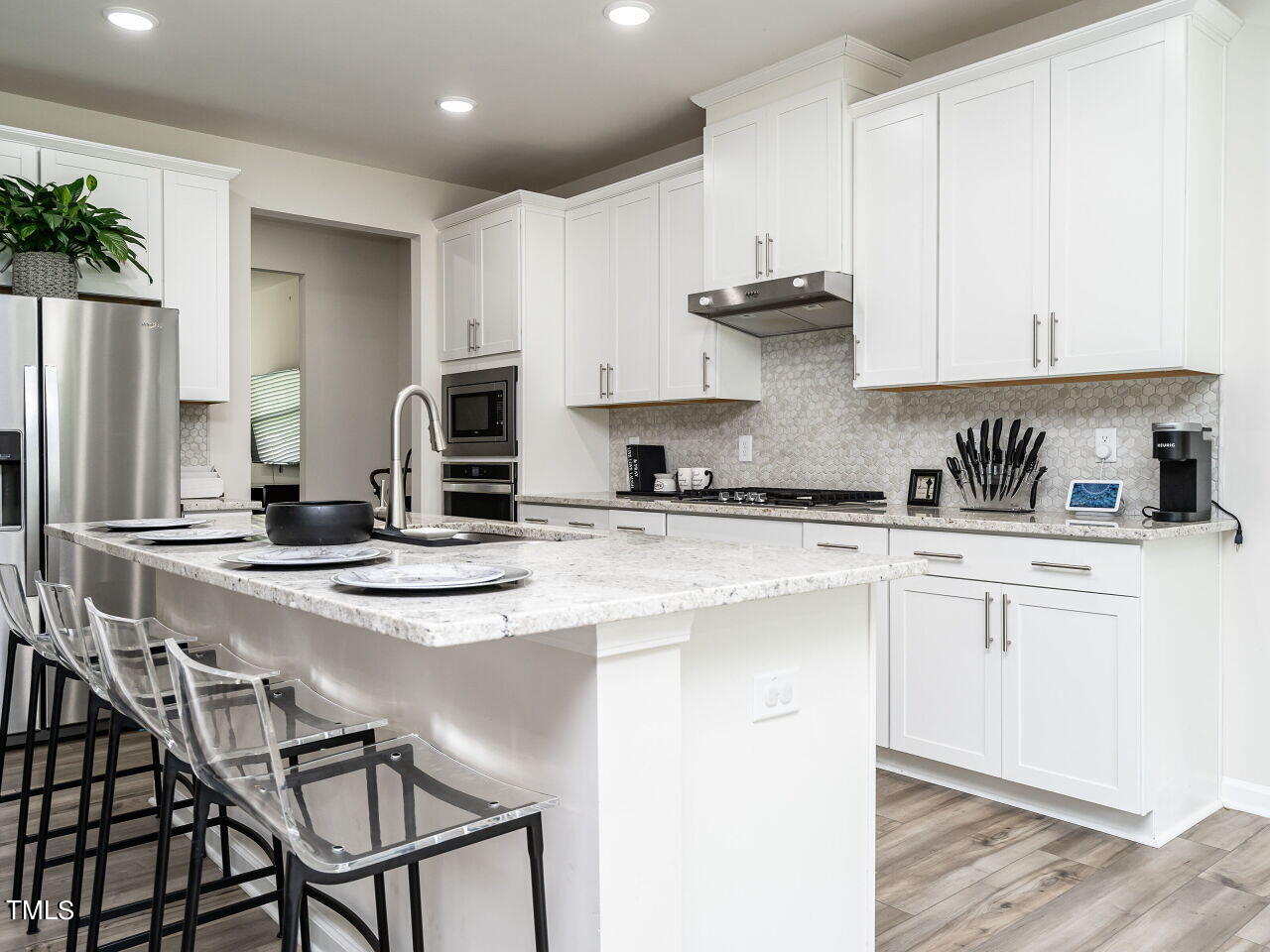 633 Embrun Run Wendell, NC 27591 - Photo 10 of 32 a kitchen with stainless steel appliances granite countertop a stove a sink and a refrigerator