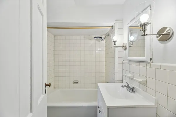 a bathroom with a bathtub and shower
