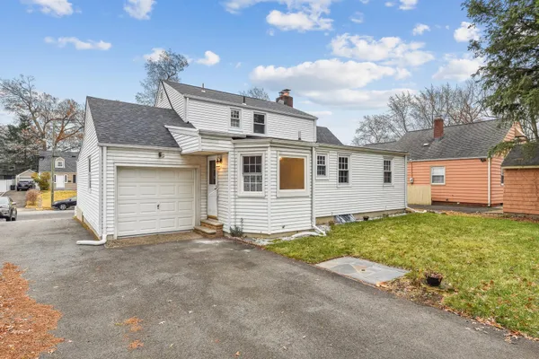a view of a house with a yard and garage