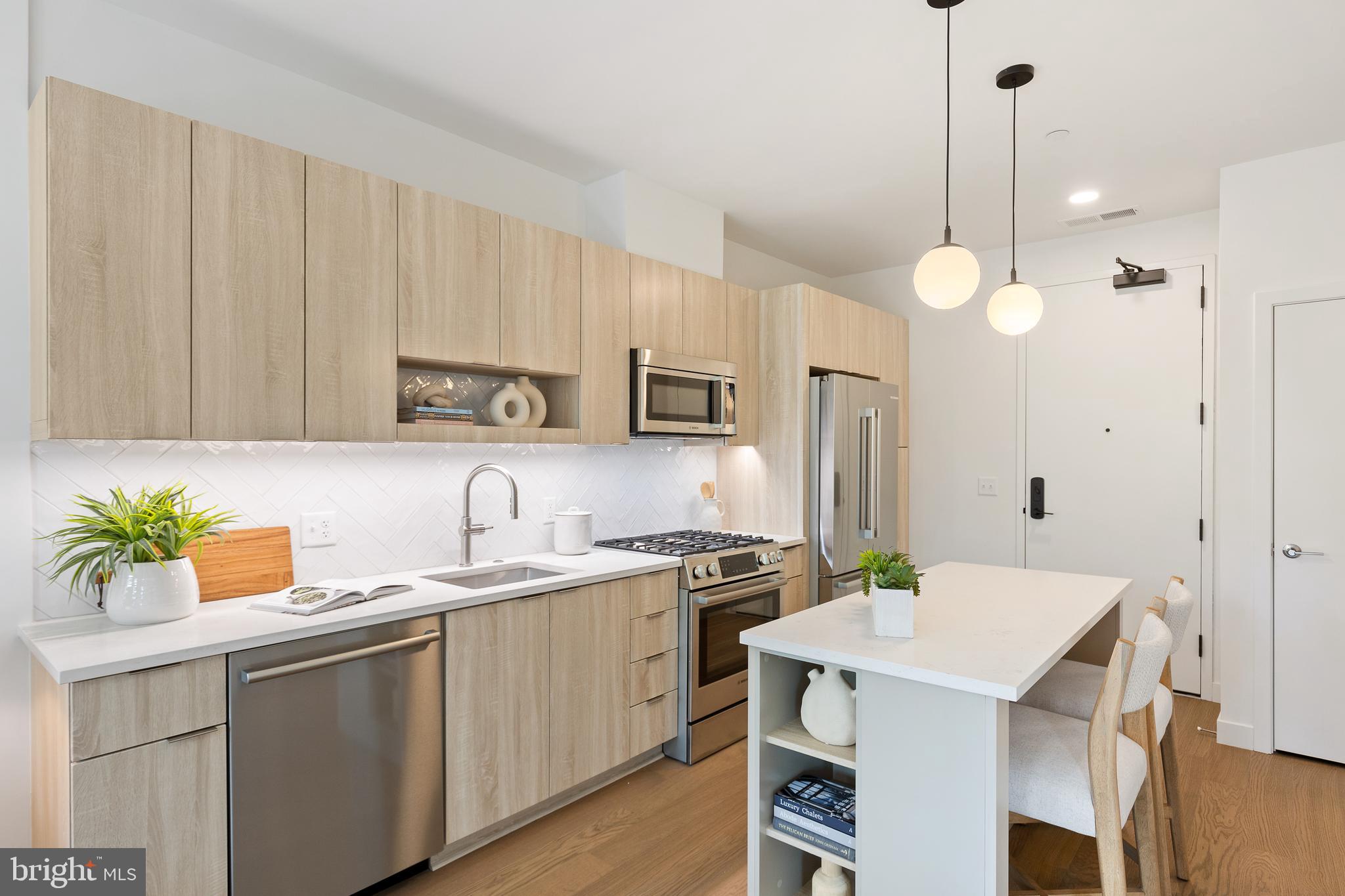 a kitchen with a sink a stove a center island and cabinets