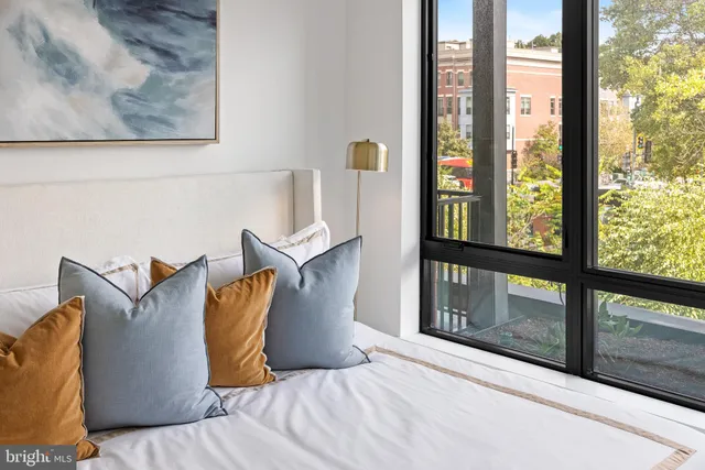 a kitchen with stainless steel appliances a stove a microwave cabinets and a counter top space