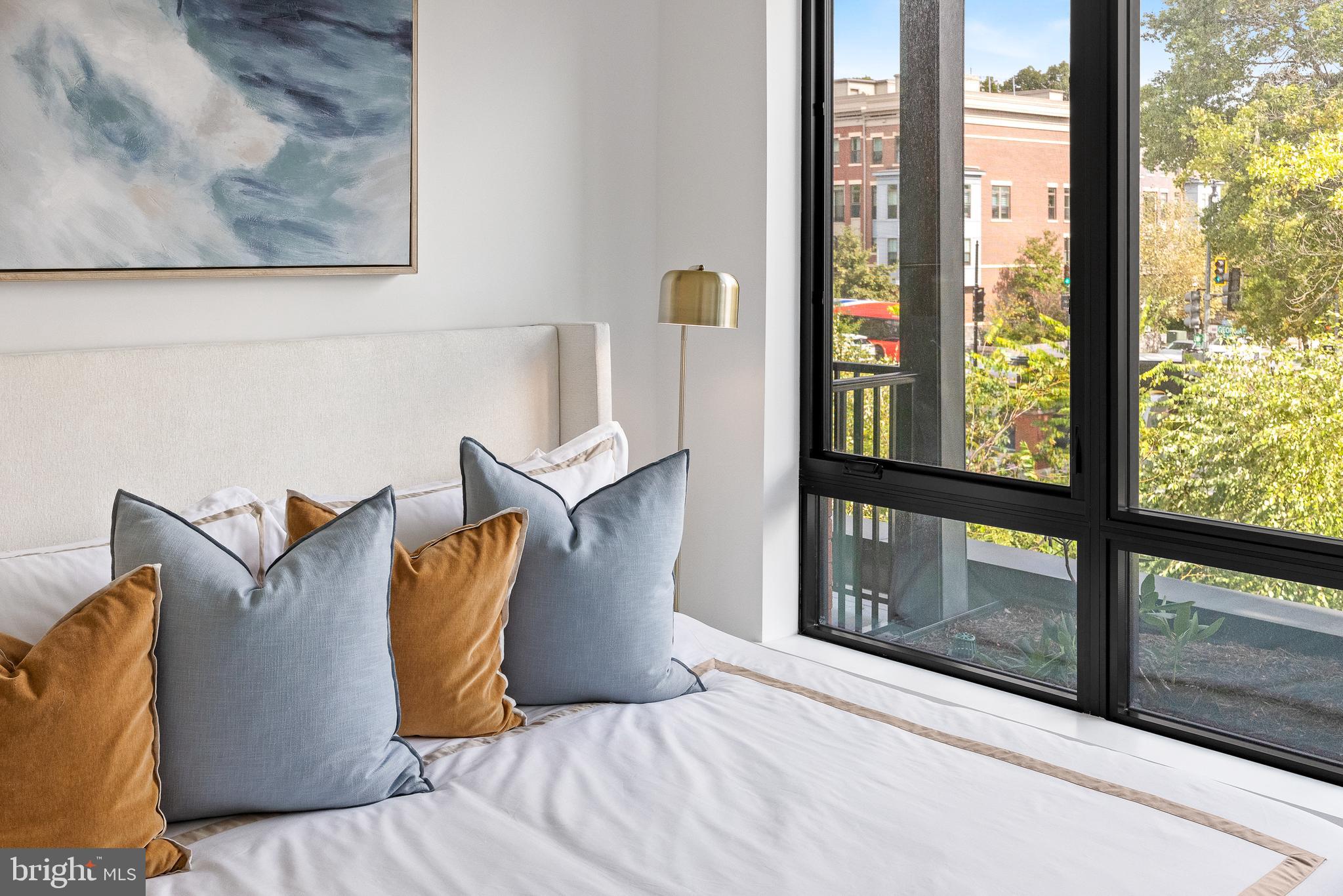7175 12th Street Northwest, Unit 405 Washington, DC 20012 - Photo 19 of 63 a bed sitting in a bedroom next to a window