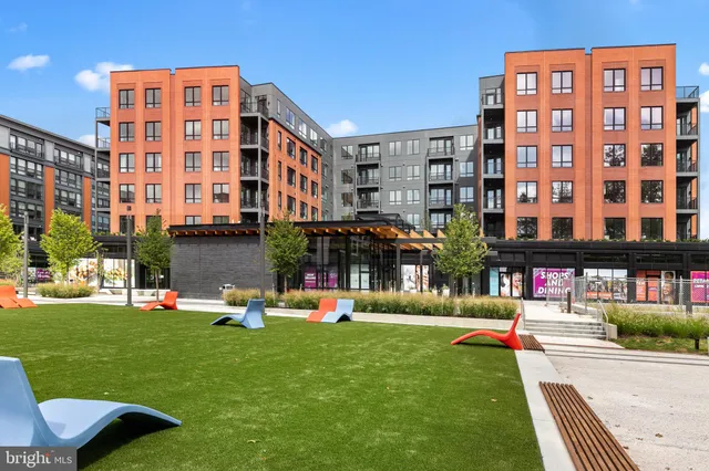 a building outdoor space with patio furniture and a potted plant