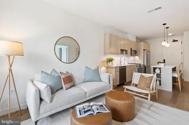 a living room with furniture and a chandelier