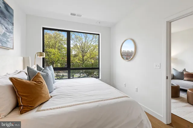a bathroom with a granite countertop sink toilet a large mirror a shower and a bathtub