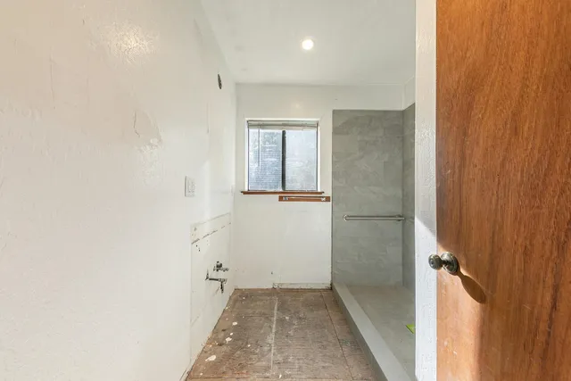 a brick building with a bench in front of it