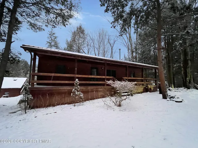 a view of backyard with two chair and a fire pit