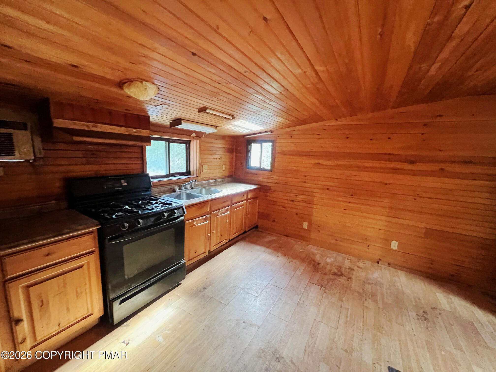 2564 Hills Creek Lake Road Wellsboro, PA 16901 - Photo 24 of 26 a kitchen with stainless steel appliances granite countertop a stove a sink and a microwave