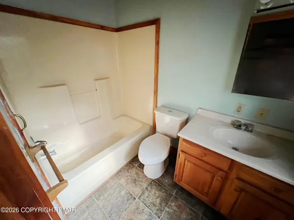 a bathroom with a toilet a sink and bathtub