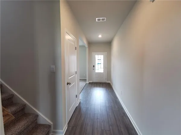 a view of a hallway with wooden floor