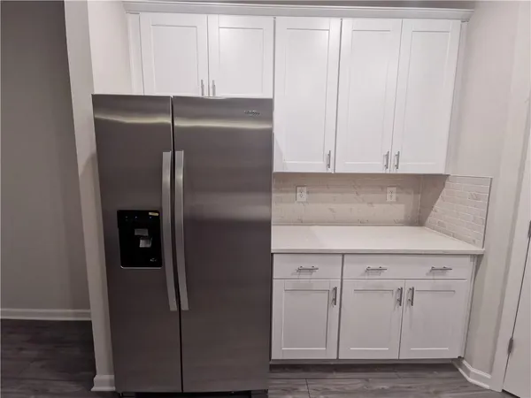 a kitchen with cabinets and a refrigerator
