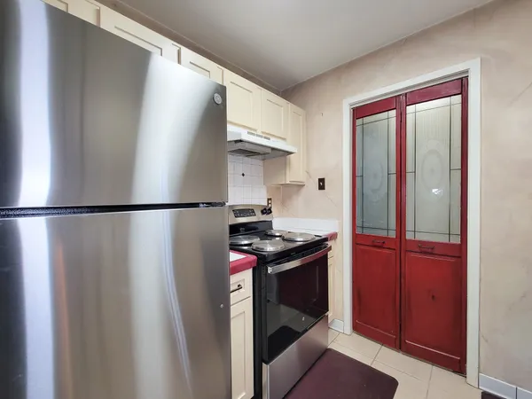 a kitchen with stainless steel appliances granite countertop a refrigerator and a stove
