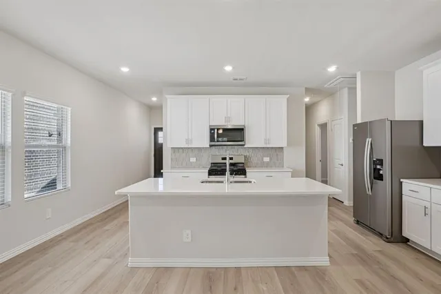 a large kitchen with stainless steel appliances