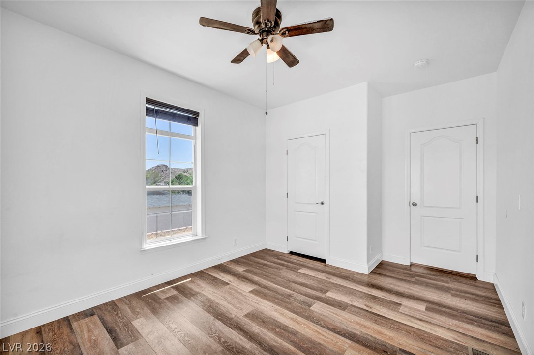 225 California Street Searchlight, NV 89046 - Photo 34 of 64 Wood plank flooring and a ceiling fan complete this comfortable bedroom.