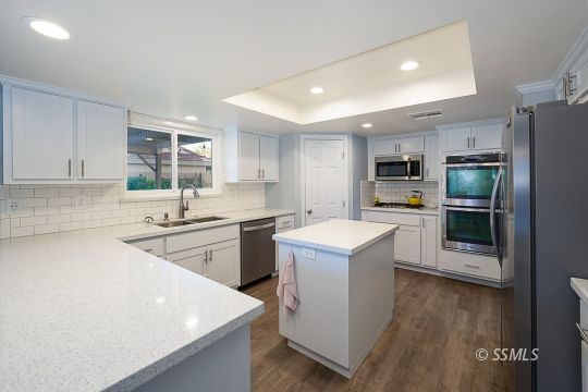 223 West Cobblestone Lane Ridgecrest, CA 93555 - Photo 3 of 34 a kitchen with a sink a stove a refrigerator and a oven