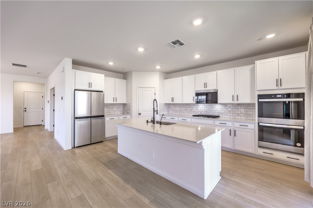 3782 Alla Rocca Avenue Henderson, NV 89044 - Photo 12 of 55 This kitchen features a central island, modern appliances, and a seamless flow for effortless living.